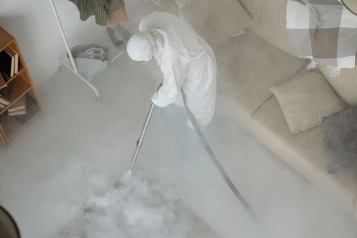 Biohazard cleanup technician in protective equipment, Lexington, TX